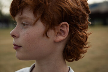 Ginger boy in nature in summer