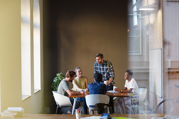 Fototapeta premium Creative business people working at tables in sunny office