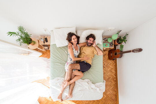 Joking couple on bed