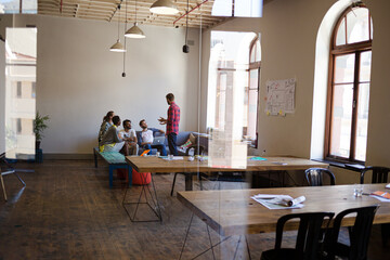 Creative business people talking in circle in office