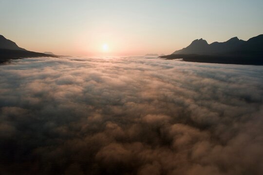 Flying, dreaming above golden cloudscape, aerial