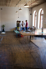 Creative business people talking in circle in office