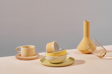 Set of simple elegant yellow tableware on yellow background