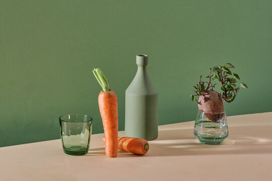 Glassware set with drink glass and vase on green