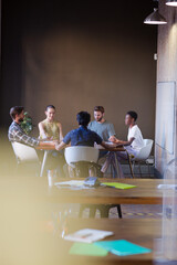 Casual business people working at tables in open office