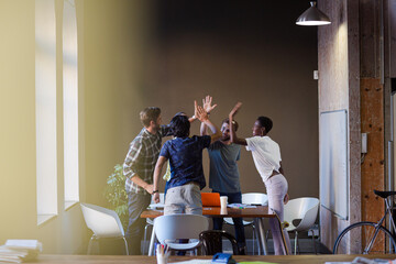 Casual business people working at tables in open office