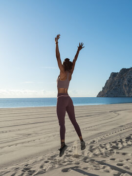 Sportswoman enjoying freedom on beach