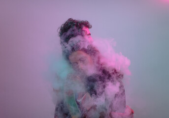 Couple hug inside a smoke cloud