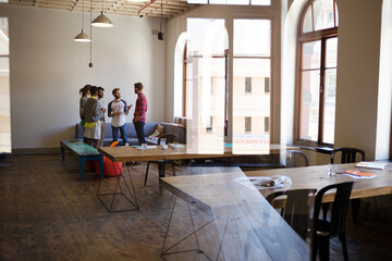 Creative business people talking in circle in office