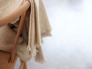 Beige blanket on chair.