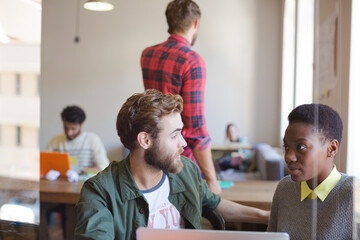 Creative business people working at laptop in office