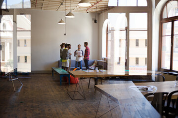 Creative business people talking in circle in office