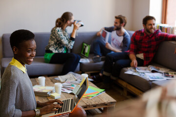 Creative business people playfully posing for coworker instant camera