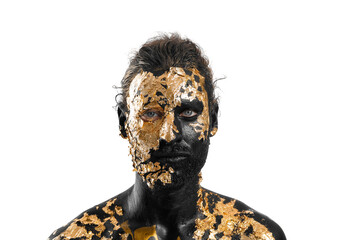 Handsome young man with black and golden paint on body against white background