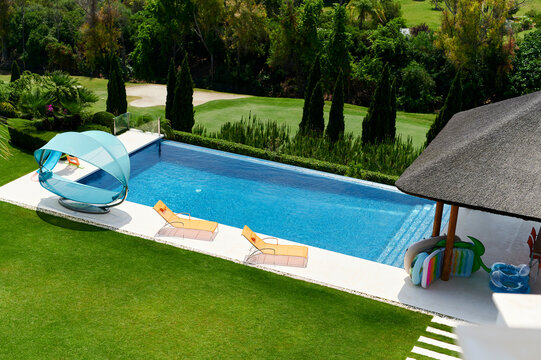Swimming pool on a patio next to a golf course
