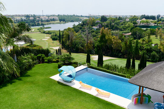 Pool with a scenic view of a golf course