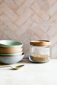 Glass food storage jar and ceramic bowls