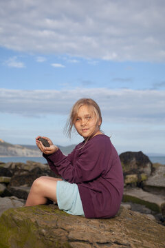 Girl holding ammonite fossil