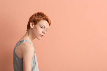 Teenage boy with dyed eyebrows on color background