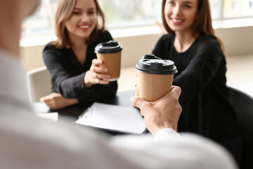 Business colleagues drinking coffee in office