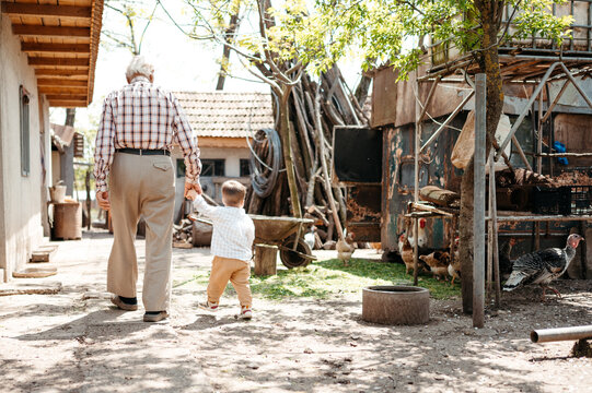 Grandfather with boy on ranch