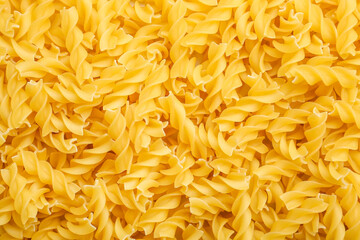 Uncooked fusilli pasta as background
