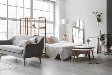 Interior of stylish room with comfortable bed