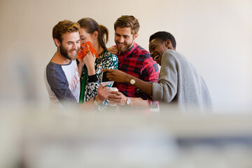 Smiling casual business people looking at instant photos