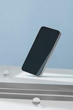 White mobile smartphone with reflection on the screen
