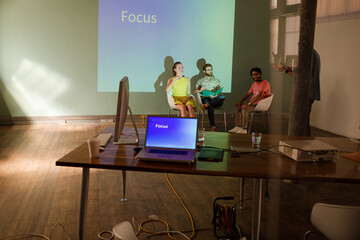 Business people preparing audio visual presentation on Focus