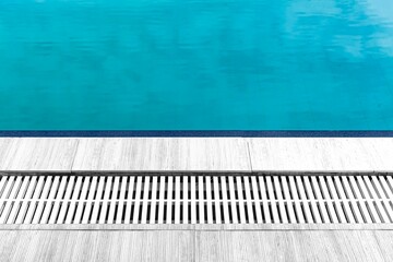 Wide swimming pool and white stone floor inside the villa