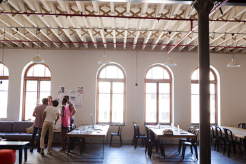 Creative business people talking in circle in office