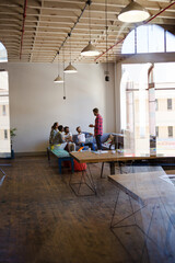 Creative business people talking in circle in office