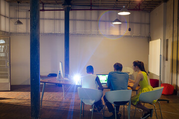 Lens flare over creative business people working in office