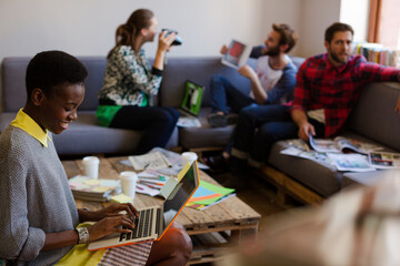 Creative business people playfully posing for coworker instant camera