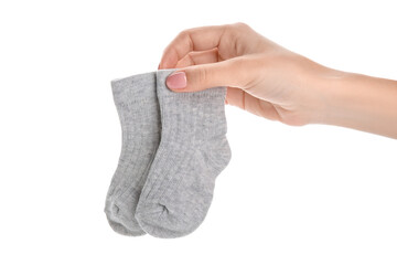 Woman holding baby socks on white background
