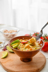 Bowl of tasty chicken curry on table