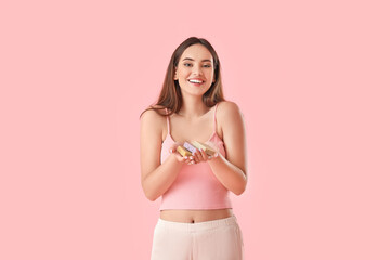 Beautiful young woman with soap on color background