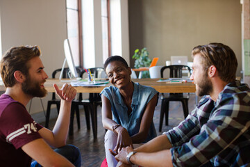 Casual business people meeting in circle in sunny office