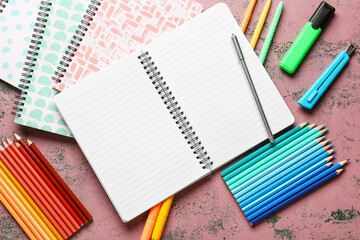 Blank notebook and stationery supplies on grunge background