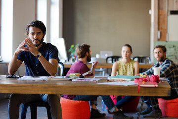 Portrait confident casual businessman in sunny office