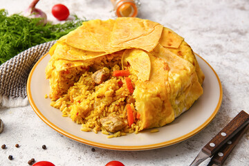 Plate with tasty Shah Pilaf on light background