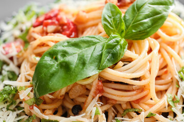 Tasty Pasta Puttanesca as background, closeup