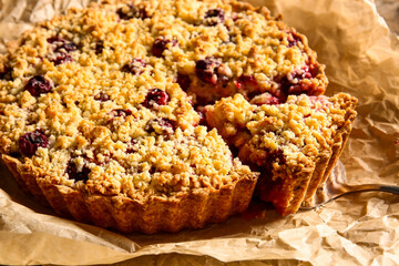 Parchment with tasty cherry pie, closeup