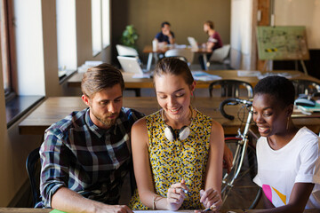 Casual business people discussing paperwork in office