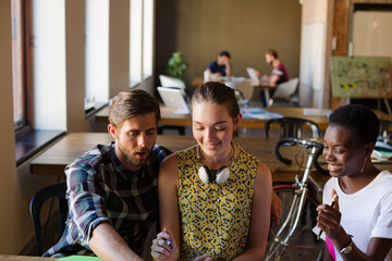 Casual business people discussing paperwork in office