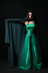 Naklejka premium Beautiful woman dressed as witch for Halloween on dark background