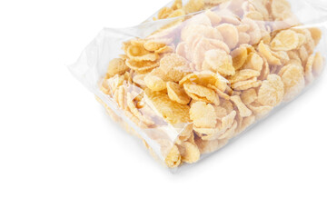 Bag with tasty corn flakes on white background, closeup