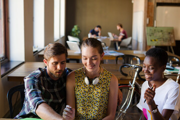 Casual business people discussing paperwork in office