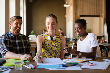 Casual business people discussing paperwork in office